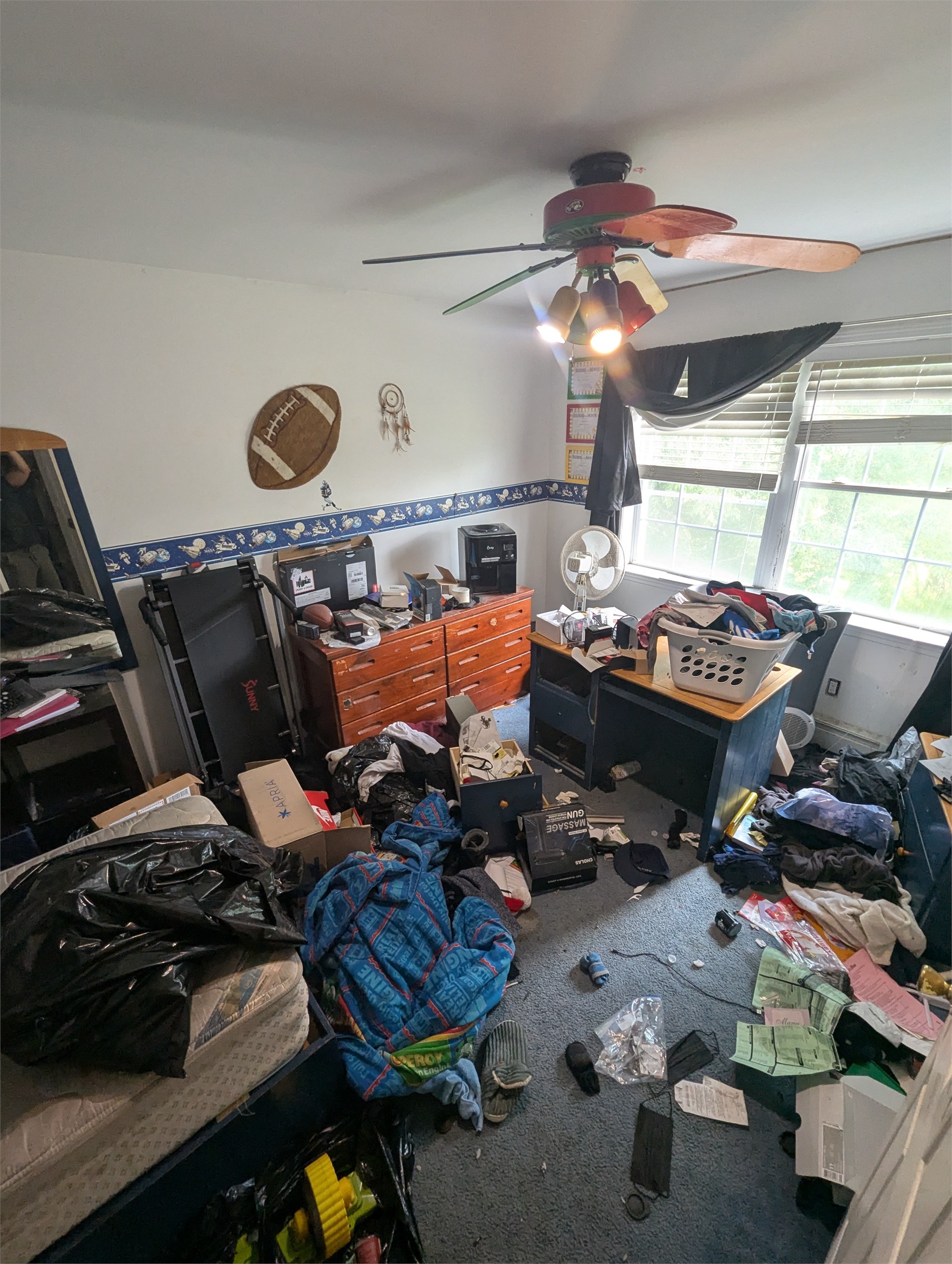 Cluttered bedroom before an apartment cleanout
