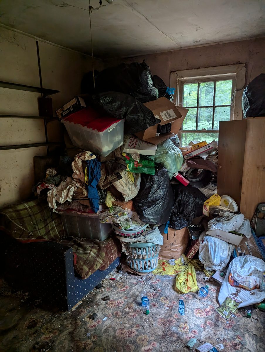 Cluttered room before a whole-property cleanout near the Village of Florida