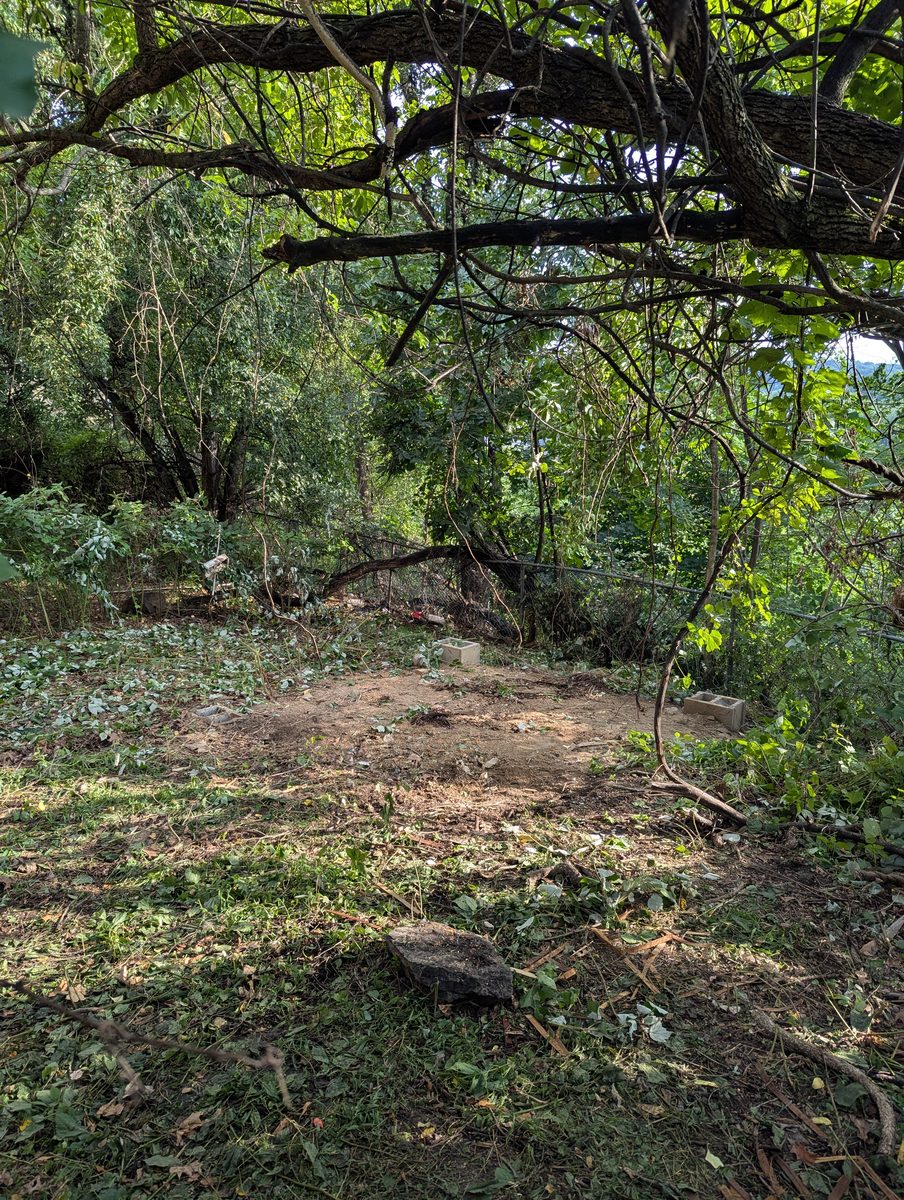 Cleared backyard area after shed removal in Kiryas Joel, New York
